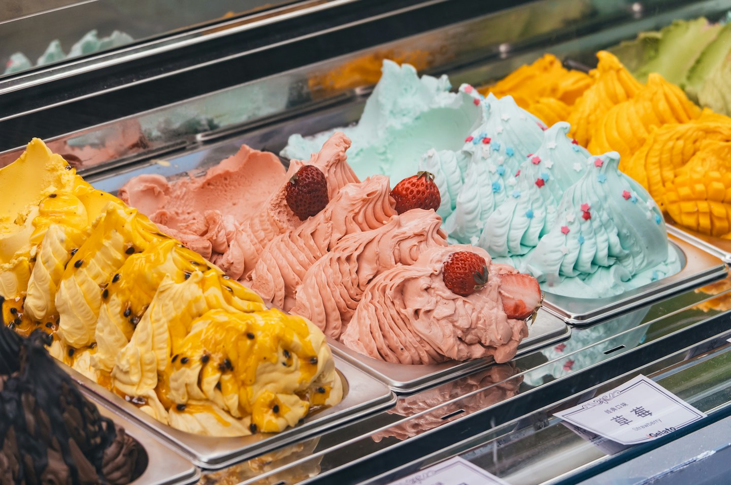 Artisanal gelato flavors in a refrigerated case.