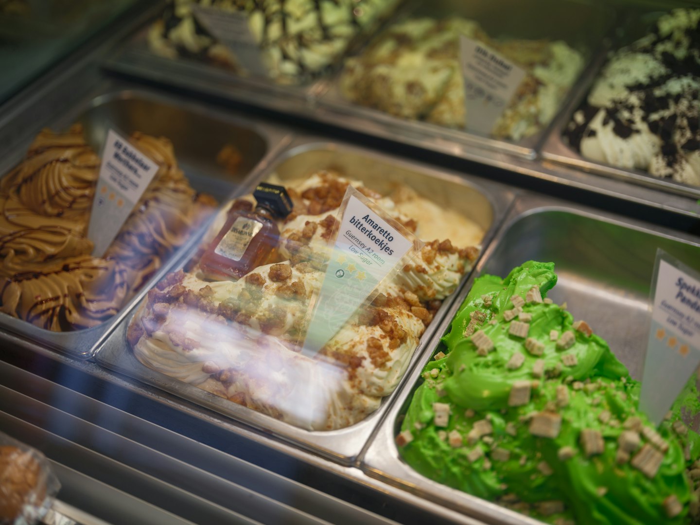 Colorful gelato scoops displayed in a chilled serving case.